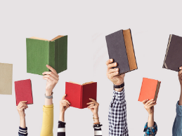 photo of arms reaching up holding books