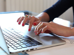 Image of hands typing on a laptop keyboard