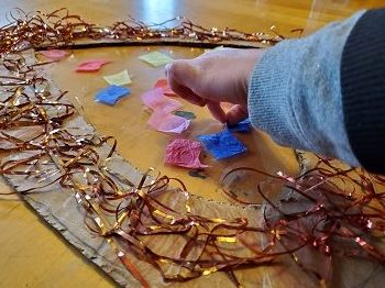 child decorating tissue paper stained glass