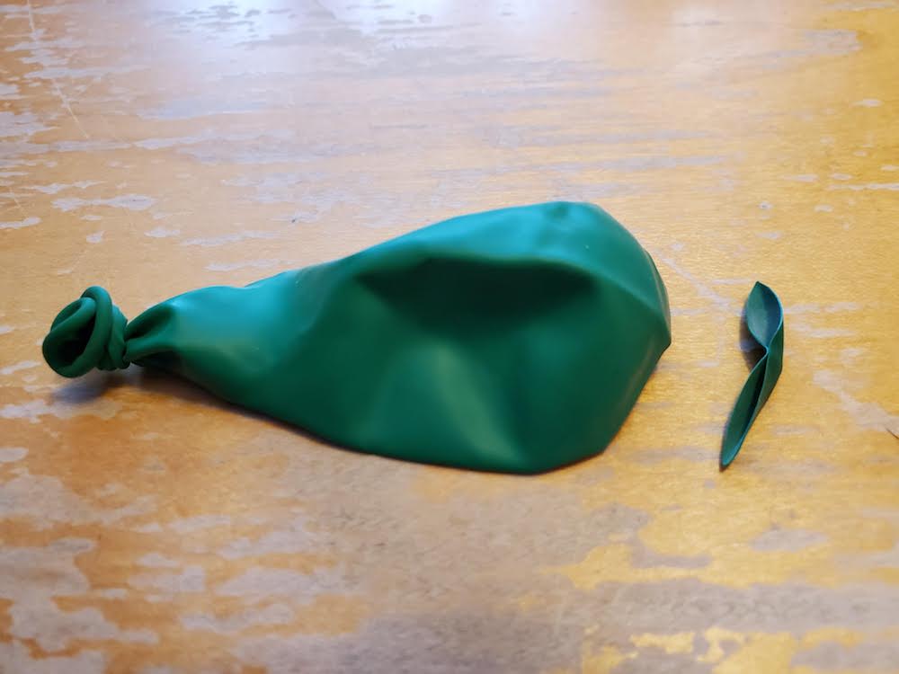 image of a deflated balloon with a hole in it