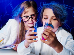 photo of two children conducting an experiment